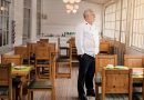 Restaurant-owner-standing-in-his-empty-restaurant