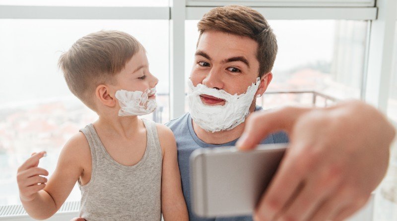 little-boy-and-father-have-fun-playing-shave-together-smiling-while-taking-selfie