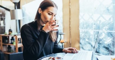 young-woman-sitting-in-coffee-shop-using-technology-to-work-anywhere